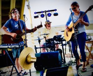 remedy-photo Remedy live band playing on a deck over water
